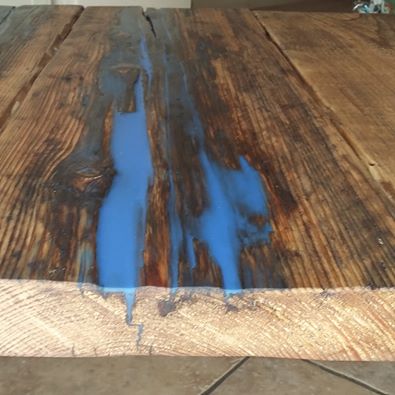 Industrial style table made from reclaimed wood and resin